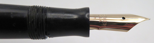 Comes with Parker Duofold Jr desk fountain pen in black with gold filled trim. Nib is Fine. Button filler.